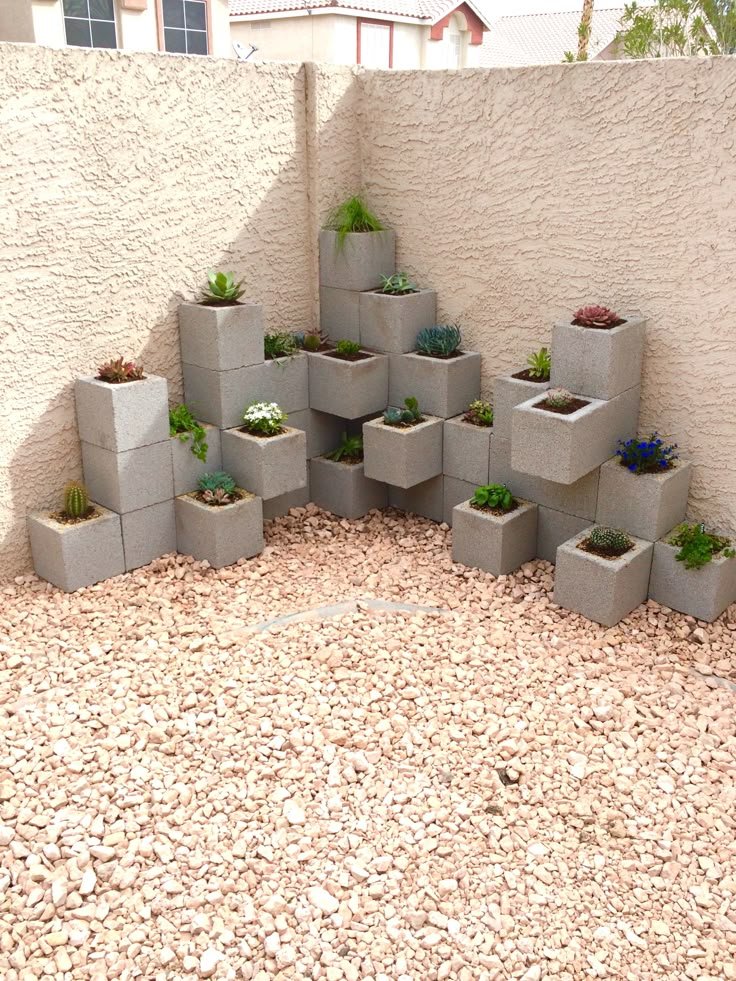 Corner garden made with stacked concrete blocks and small plants