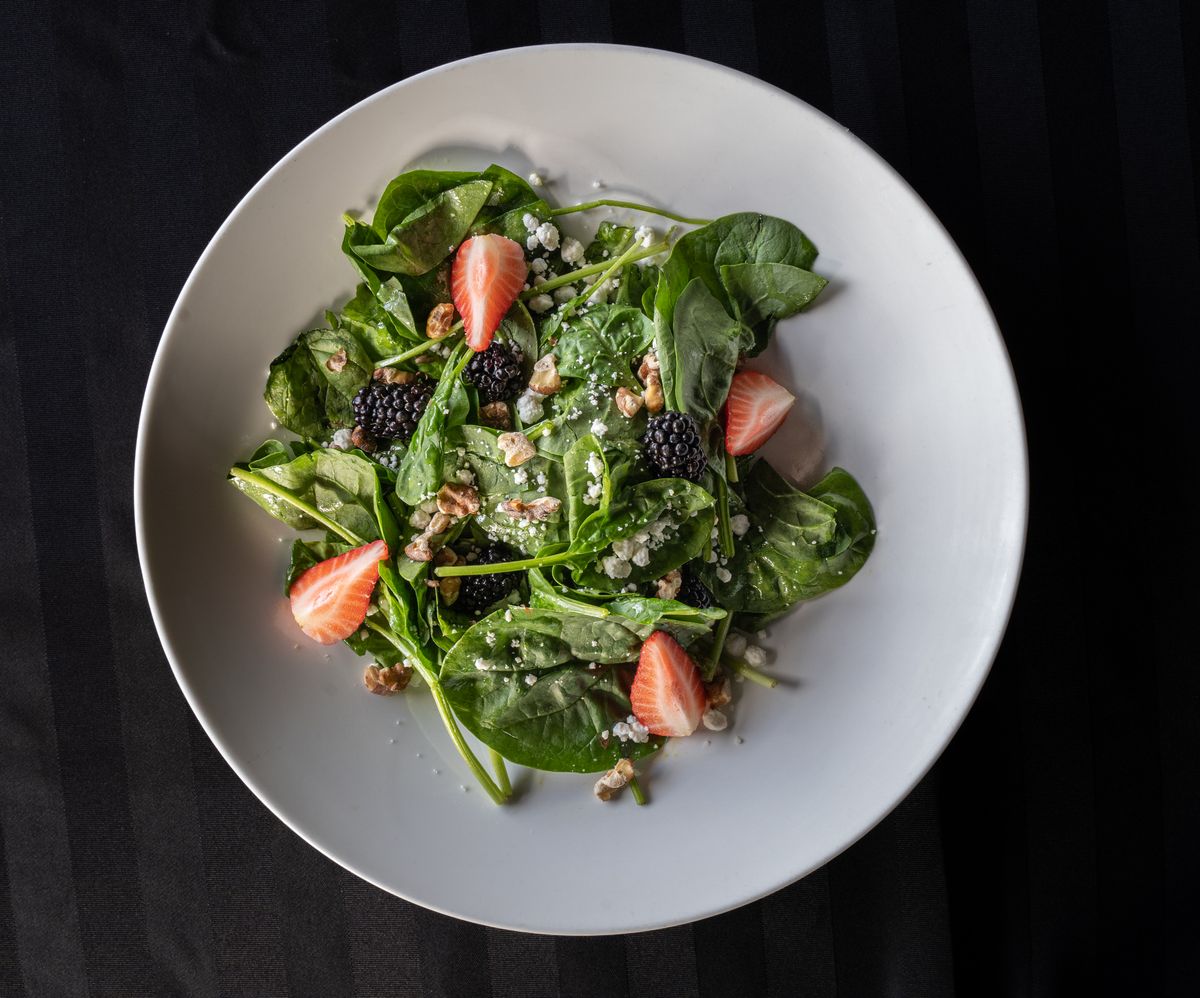 Fresh salad with blackberries, greens, cheese, and nuts