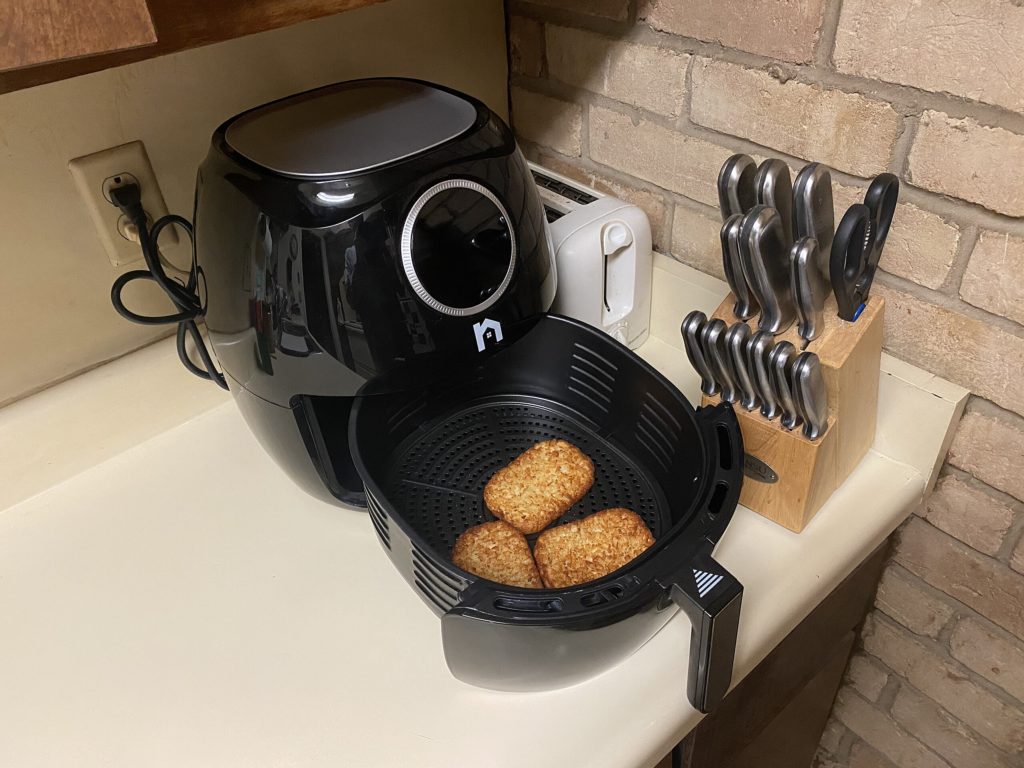 An air fryer in a kitchen, reason to unplug appliances