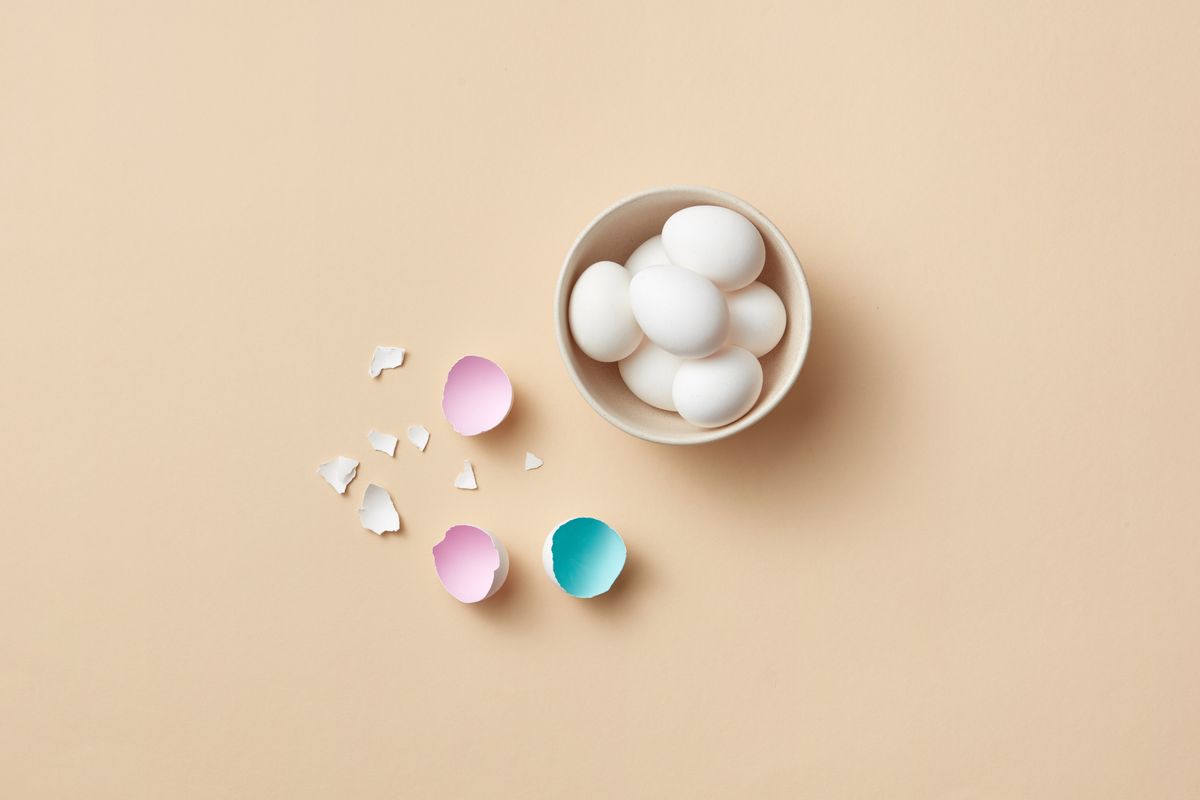 Clean eggshells collected in a small bowl on a kitchen counter