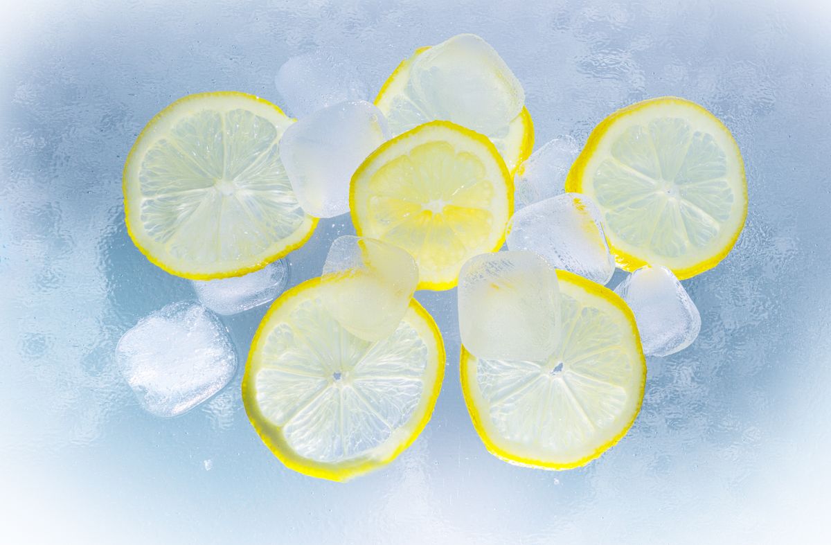 Fresh lemon slices beside a glass of water