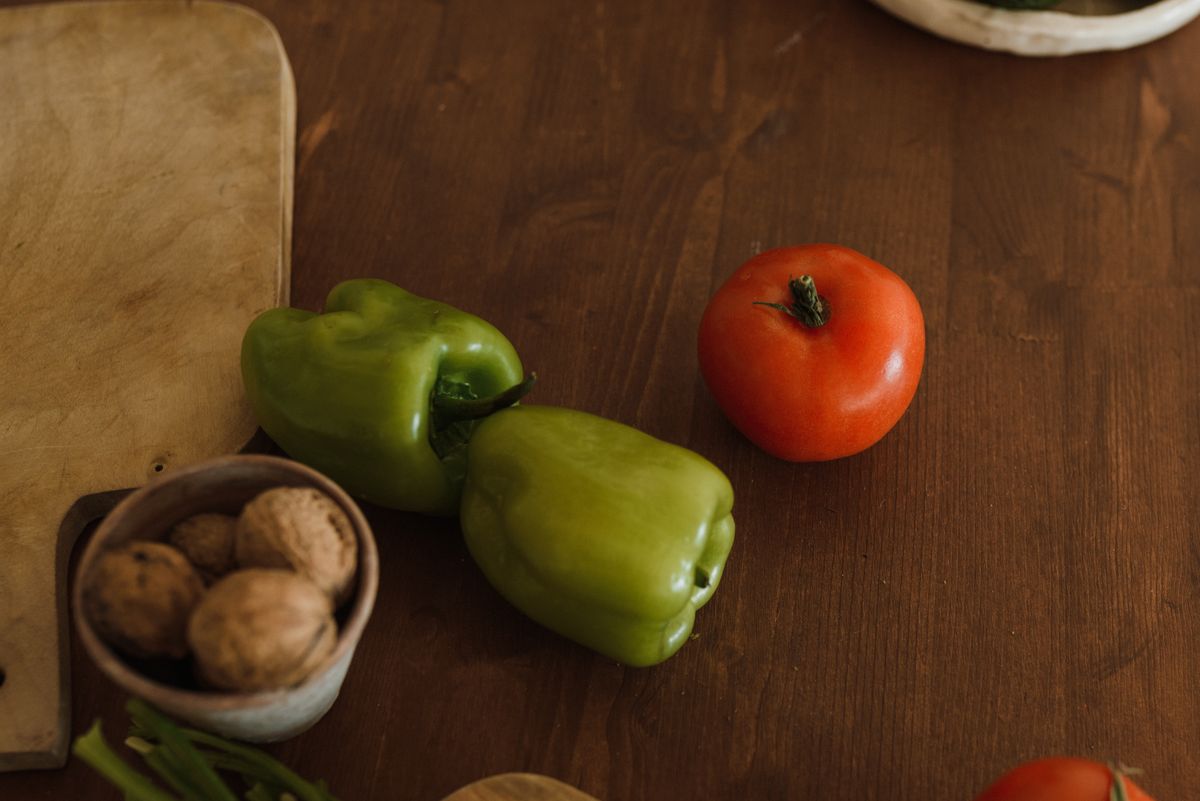 A table filled with colorful healthy foods including fruits, vegetables, nuts, and grains