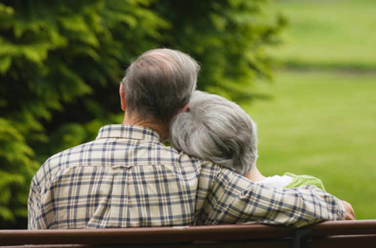 Senior couple holding hands