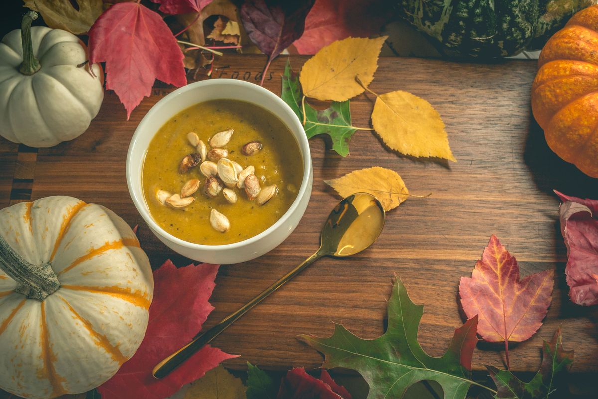 A small bowl filled with pumpkin seeds on a kitchen table