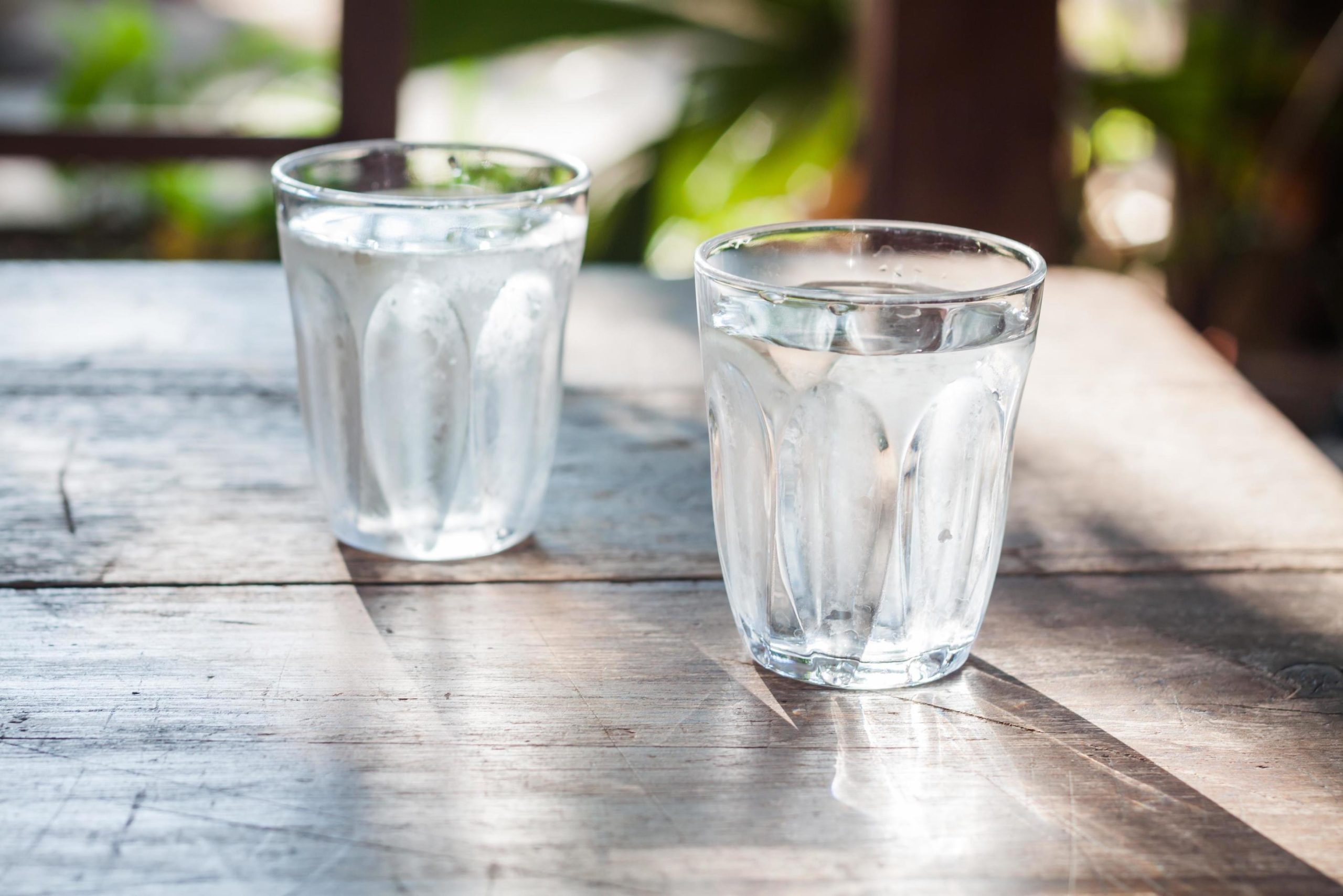 Two glasses of water placed on a table