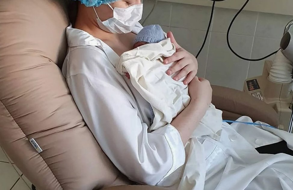 A father in skin-to-skin contact with a premature baby