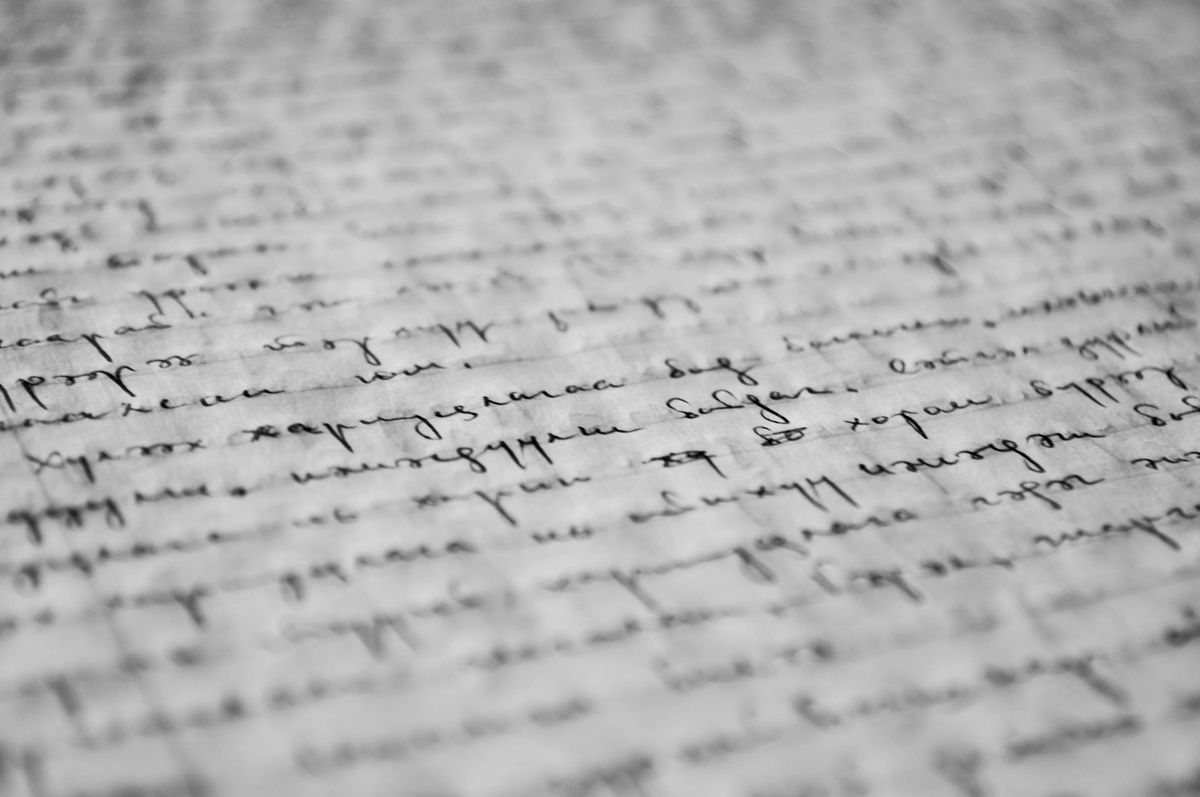 Hands holding old letters tied with a ribbon