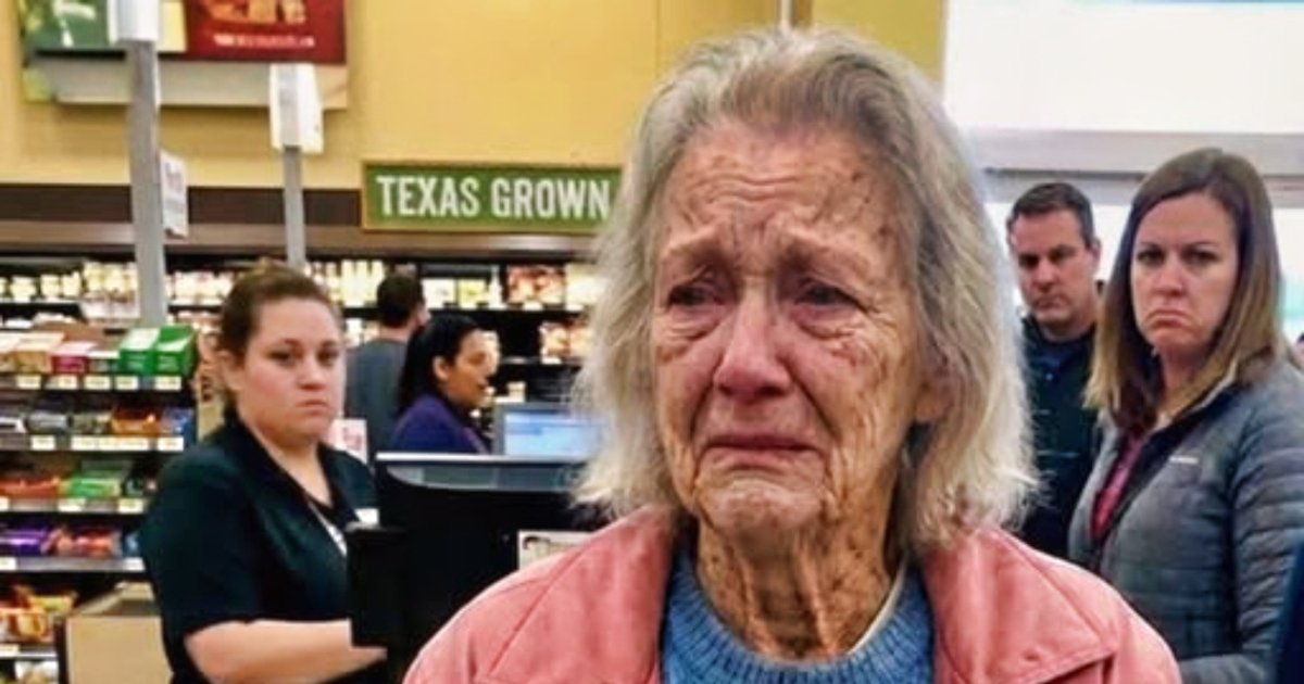 An elderly woman at the supermarket checkout