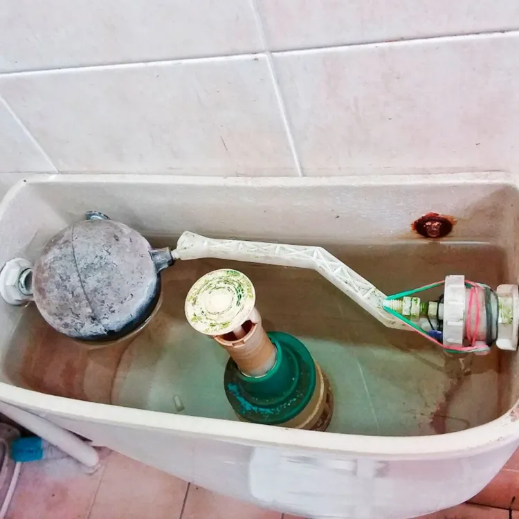 Toilet tank with white deposits