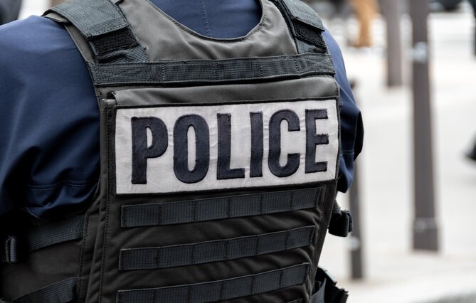 Bulletproof vest with POLICE inscription worn by a policeman in Paris