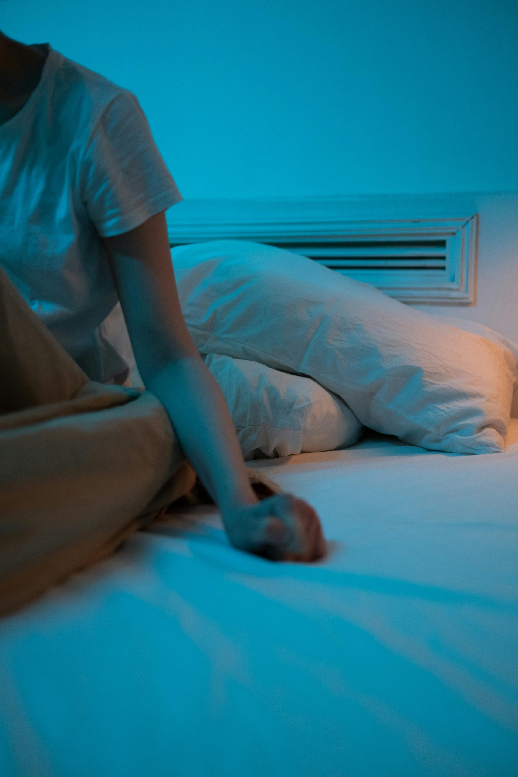 Tired person lying in bed