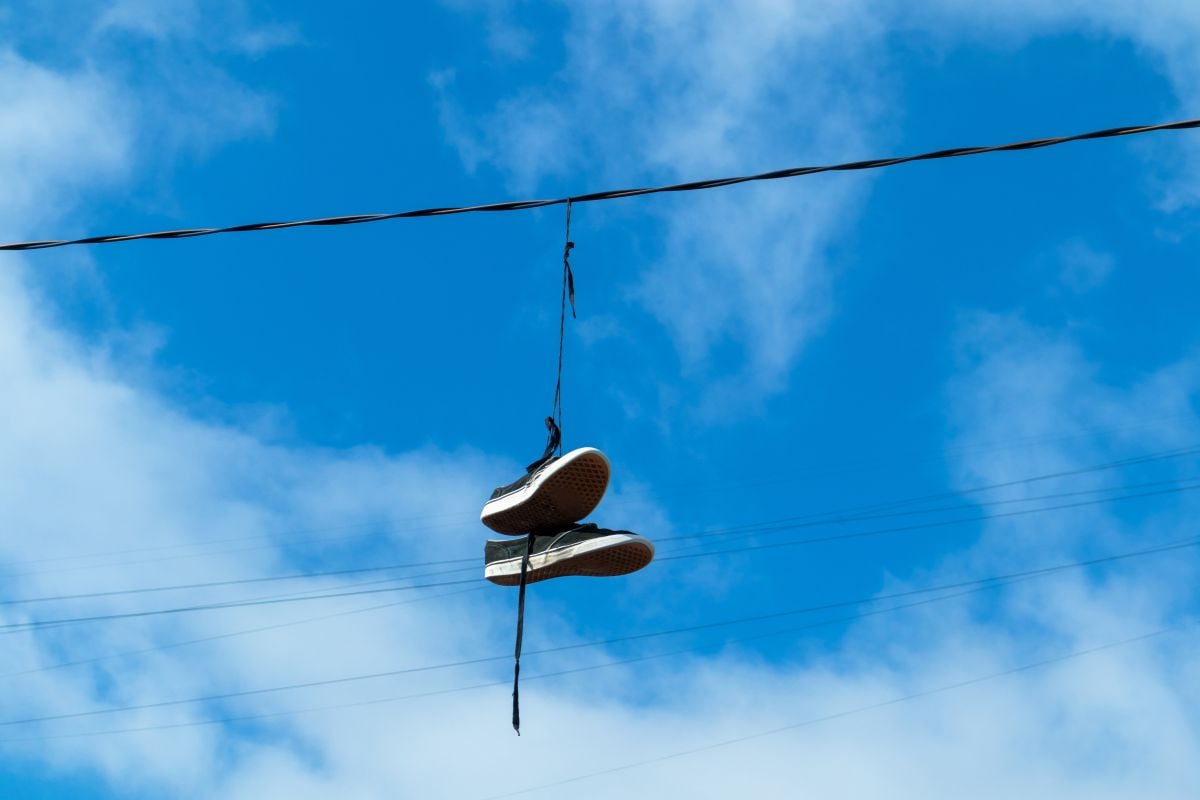Shoes hanging on an electric wire